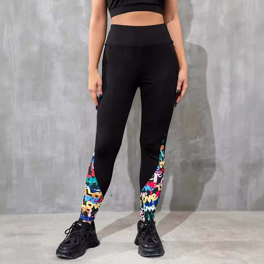 Women's high waist black leggings with colorful contrast patchwork detail on lower legs for fitness and yoga.