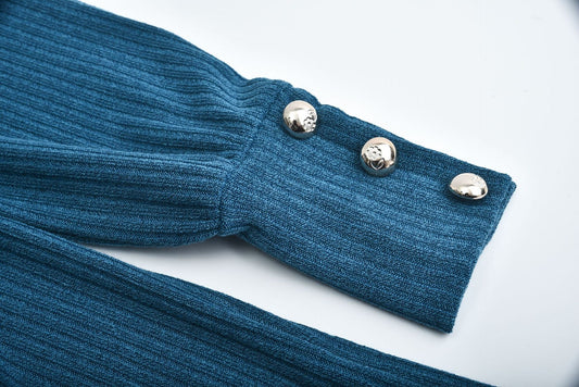 Close-up of blue ribbed cotton blend women's lapel pullover sleeve with three silver buttons