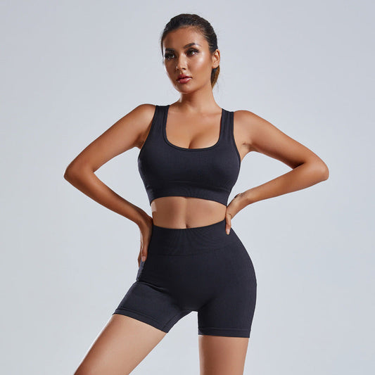 Women's seamless black yoga set with vest and high waist shorts for workout and fitness
