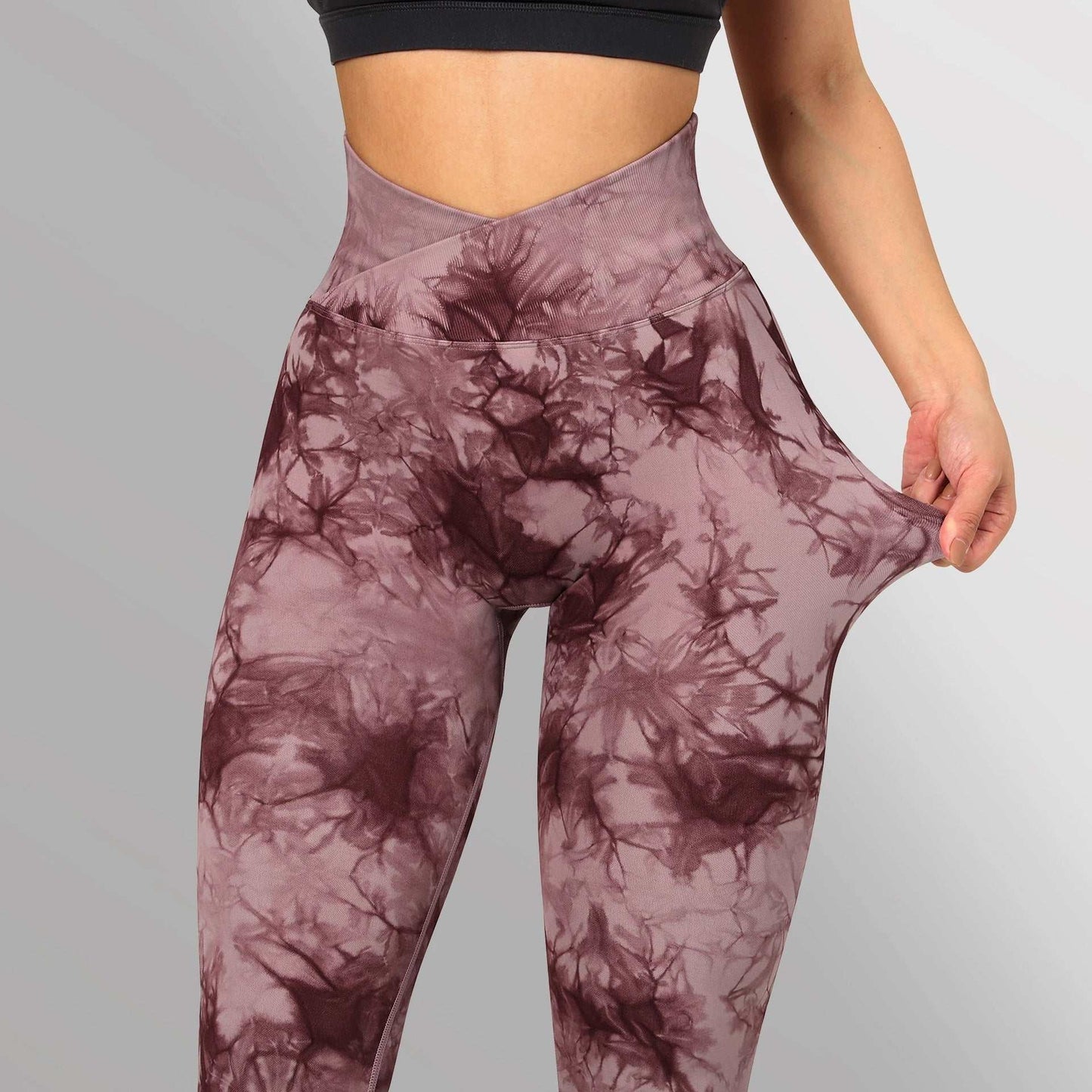 Women's seamless tie dye leggings in purple with high waistband, stretchy fabric for yoga and fitness.