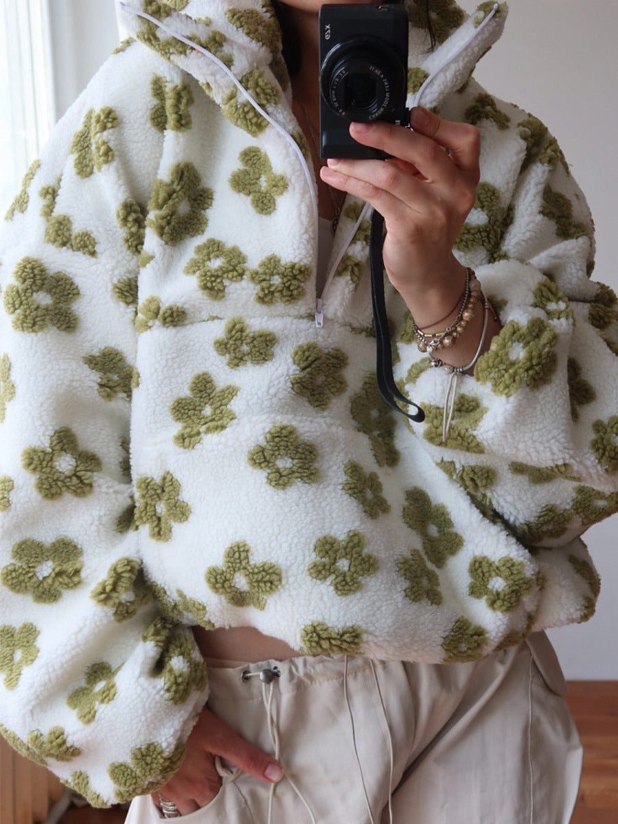 Women wearing white lambskin sweatshirt with green flower pattern and half zip-up collar in casual style