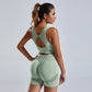Woman wearing seamless green yoga set women's vest and high waist shorts workout outfit