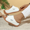 White summer wedge slides slippers with thick brown sole and fish mouth design worn by woman