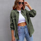 Woman wearing green ripped shirt jacket with rolled sleeves and sunglasses