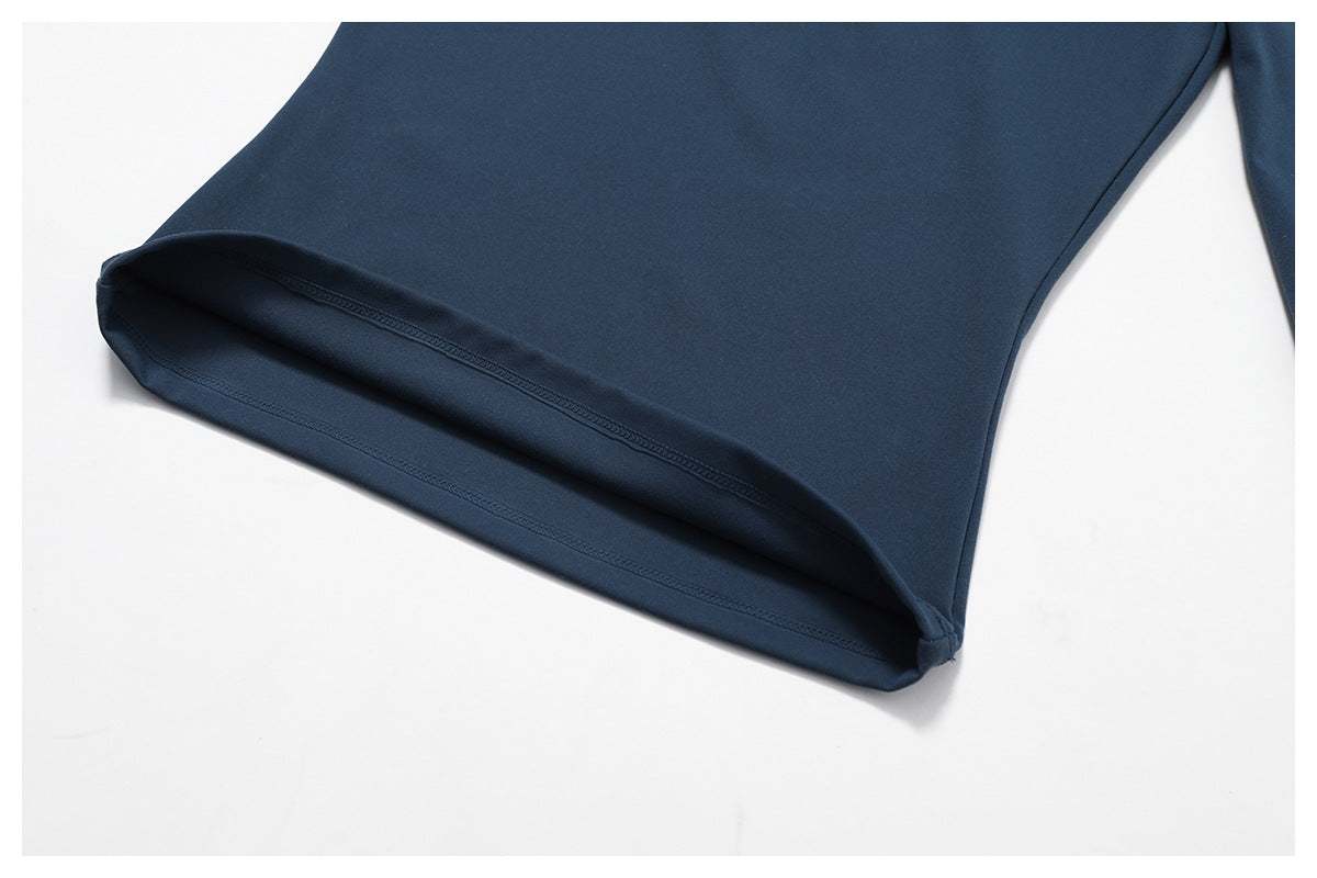 Close-up of women's slim long sleeve pullover in badge blue nylon fabric, waist length, fitness sportswear