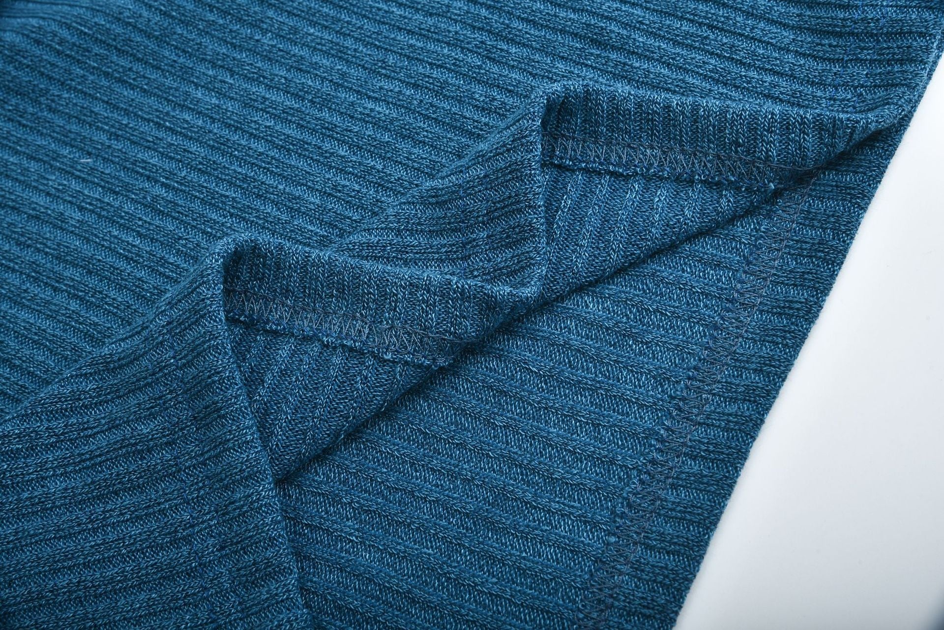 Close-up of blue cotton blend ribbed knit fabric for women's lapel pullover sweater