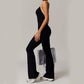 Woman wearing black Solid Beauty-back long pants jumpsuit with sneakers and transparent bag