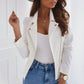 Woman wearing white zip-up lapel jacket with long sleeves and pockets paired with white top and blue jeans