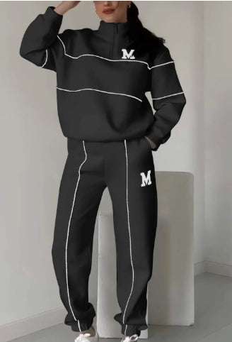 Women 2 piece black lounge sweatshirt and sweatpants set with white stripe details and pockets