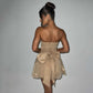 Back view of woman wearing beige tube top lace dress with large bow-knot and mesh stitching short skirt summer fashion