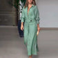Woman wearing elegant tied solid color waisted long-sleeved green shirt dress walking indoors