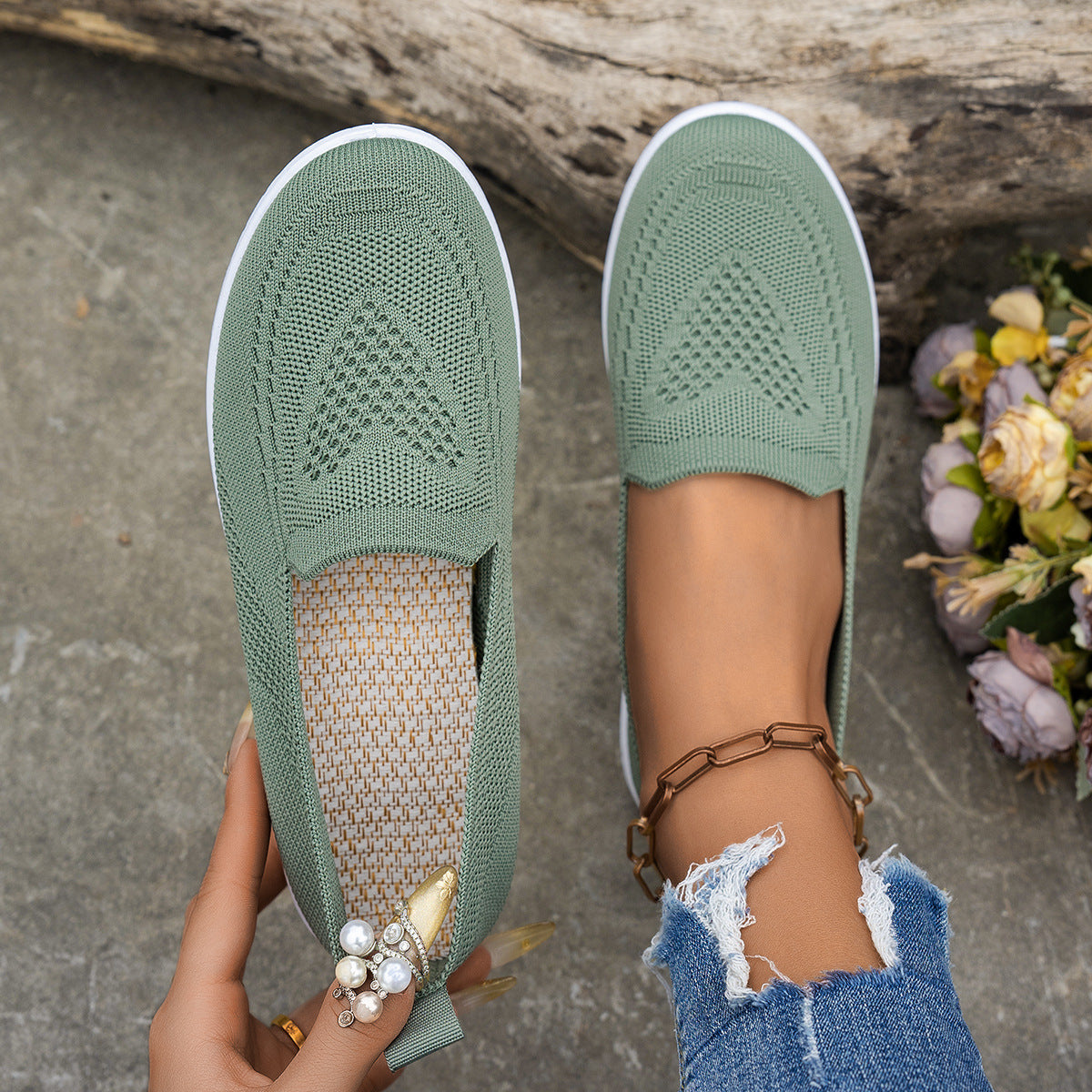 Light green women's summer mesh casual shoes with flat low heels and round toes, styled with ripped jeans and ankle bracelet outdoors