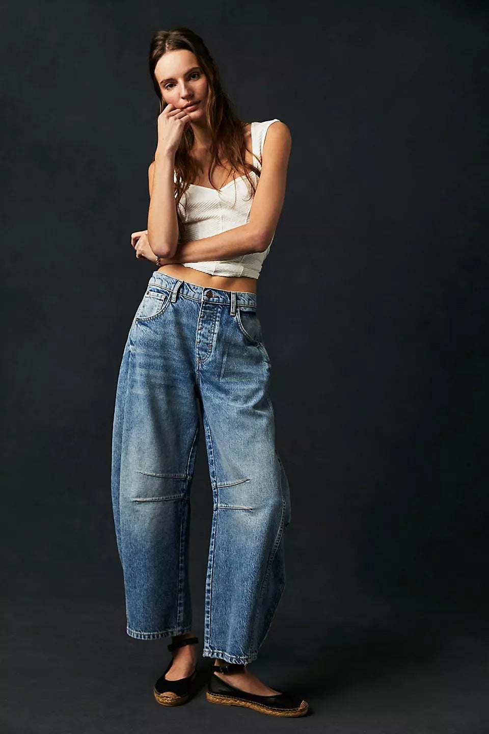 Women wearing high stretch mid-rise wide leg denim jeans with casual tank top