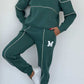 Women 2 piece green loungewear set with pullover sweatshirt and sweatpants with pockets and white stripes