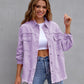 Women wearing purple ripped shirt jacket with casual jeans smiling outdoors