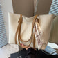 New and simple tote bag with large capacity, casual style, and versatile design in white with brown handles and decorative scarf accessory