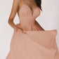Woman wearing peach-colored sexy V-neck suspender A-line summer dress
