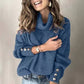 Blue women's lapel pullover knit sweater with button details on sleeves, styled with jeans.