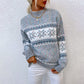 Woman wearing blue winter snowflake sweater with half turtleneck and patterned knit design