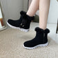 Black winter snow boots with plush ankle fur, buckle design, side zipper, and white rubber flat soles for women
