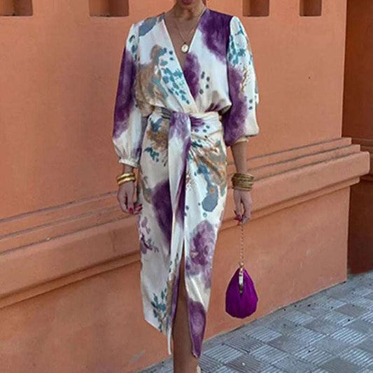 Woman wearing chic V-neck long sleeve slit midi dress two-piece suit with purple and beige floral pattern