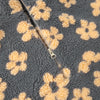 Close-up of winter flowers lambskin sweatshirt with yellow flower pattern and zipper detail