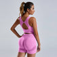 Woman wearing pink seamless yoga set women's vest and high waist shorts workout sportswear
