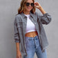 woman wearing gray ripped shirt jacket with rolled sleeves and sunglasses casual autumn spring fashion