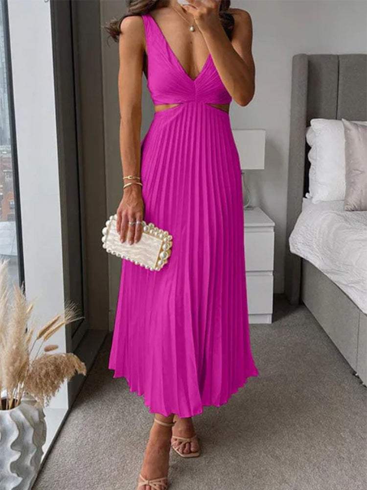 Woman wearing pink Ins suspender pleated long dress with hollow-waisted design and V-neck backless style indoors