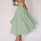Woman wearing green sexy V-neck suspender A-line summer dress with open back and strappy design