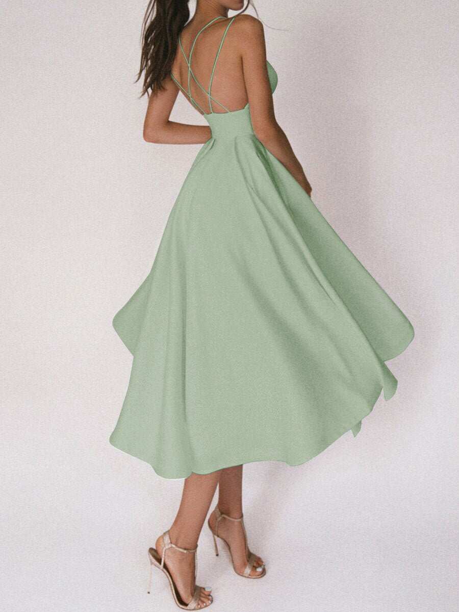 Woman wearing green sexy V-neck suspender A-line summer dress with open back and strappy design