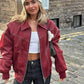 Women wearing loose fashion lapel zip-up red moto biker jacket with long sleeves and zipper closure