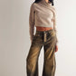 Woman wearing high stretch mid-rise loose wide leg denim jeans with brown wash and beige cropped sweater