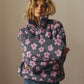 Woman wearing winter flowers lambskin sweatshirt with big front pocket and zip-up lapel in casual loose fit