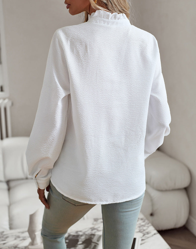 Woman wearing white ruffle collar striped long sleeve shirt back view