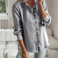 Woman wearing striped long sleeve shirt with ruffle design and button-up front in casual indoor setting