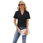 Woman wearing black V-neck hollow design T-shirt with short sleeves and blue jeans, holding a beige clutch bag