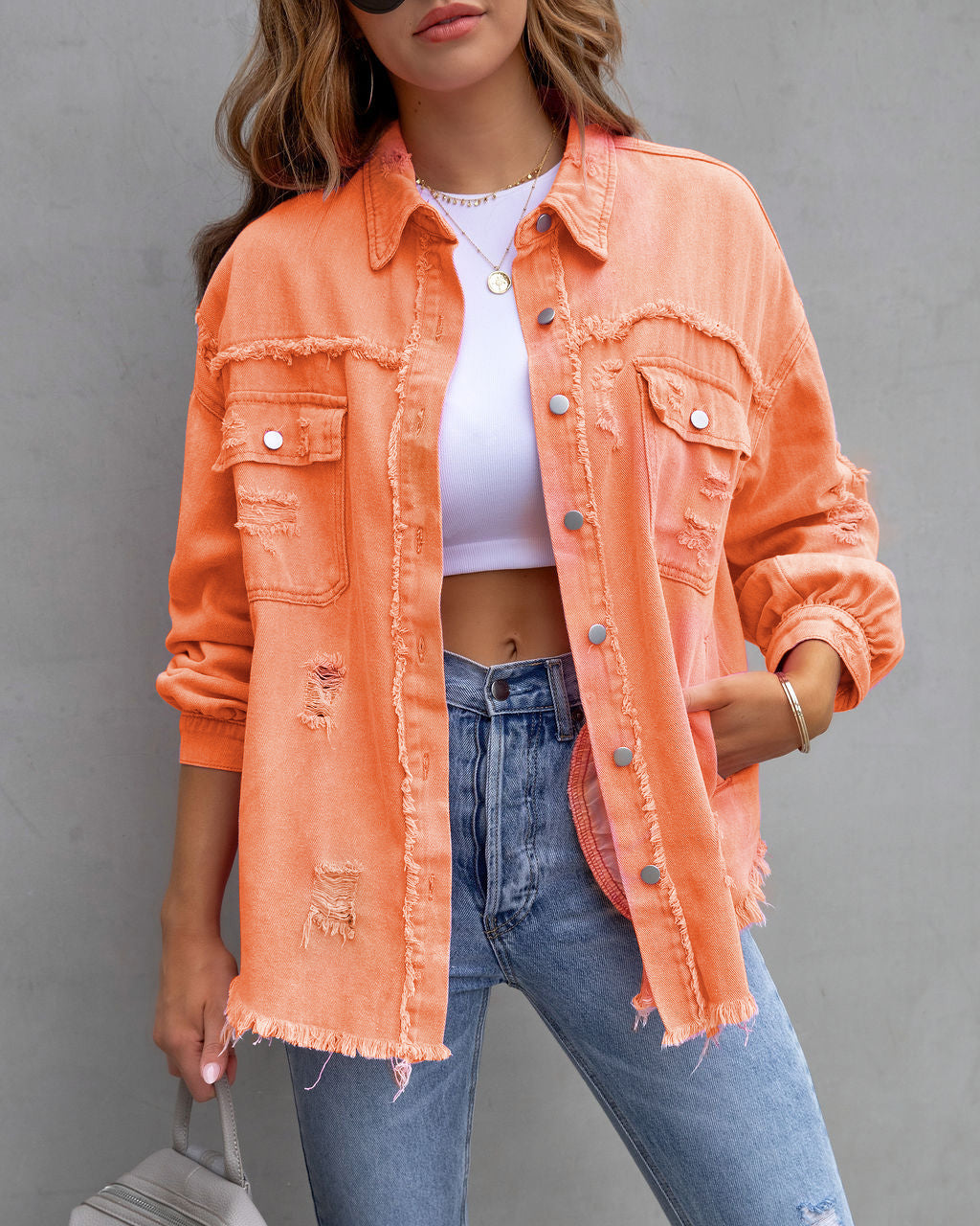 Women’s casual ripped shirt jacket in orange with distressed details and button front closure