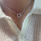 Women's fashionable minimalist silver interlocking ring clavicle necklace close-up on neck