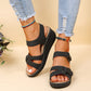 Black wedge sandals with velcro straps and breathable PU upper worn with ripped jeans