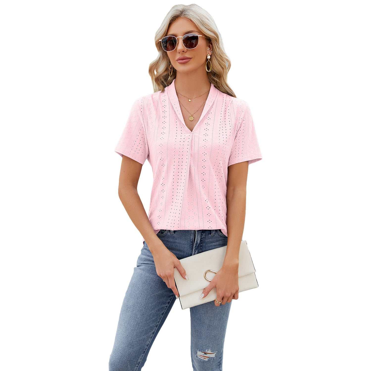 Woman wearing pink V-neck hollow design short-sleeve summer T-shirt with jeans and sunglasses