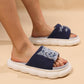 Navy blue cute cartoon kitten home slippers with thick white soles, breathable fabric upper, and non-slip rubber sole.