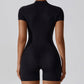 Women wearing black zipper short sleeve yoga jumpsuit with tight fit back view