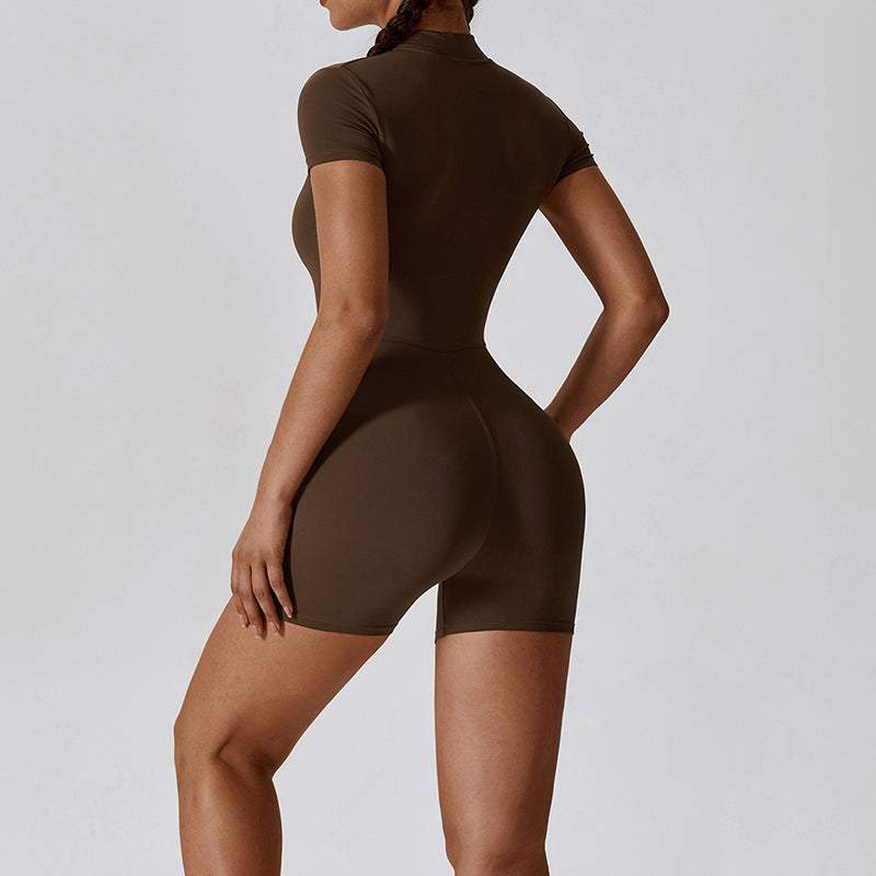 Woman wearing a brown zipper short sleeve yoga jumpsuit from the back.