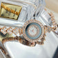 Diamond-encrusted glass rhinestone women's quartz watch in rose gold with decorative band.