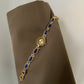 Women's agate bead bracelet watch with gold-tone alloy and blue oval stones on brown fabric background