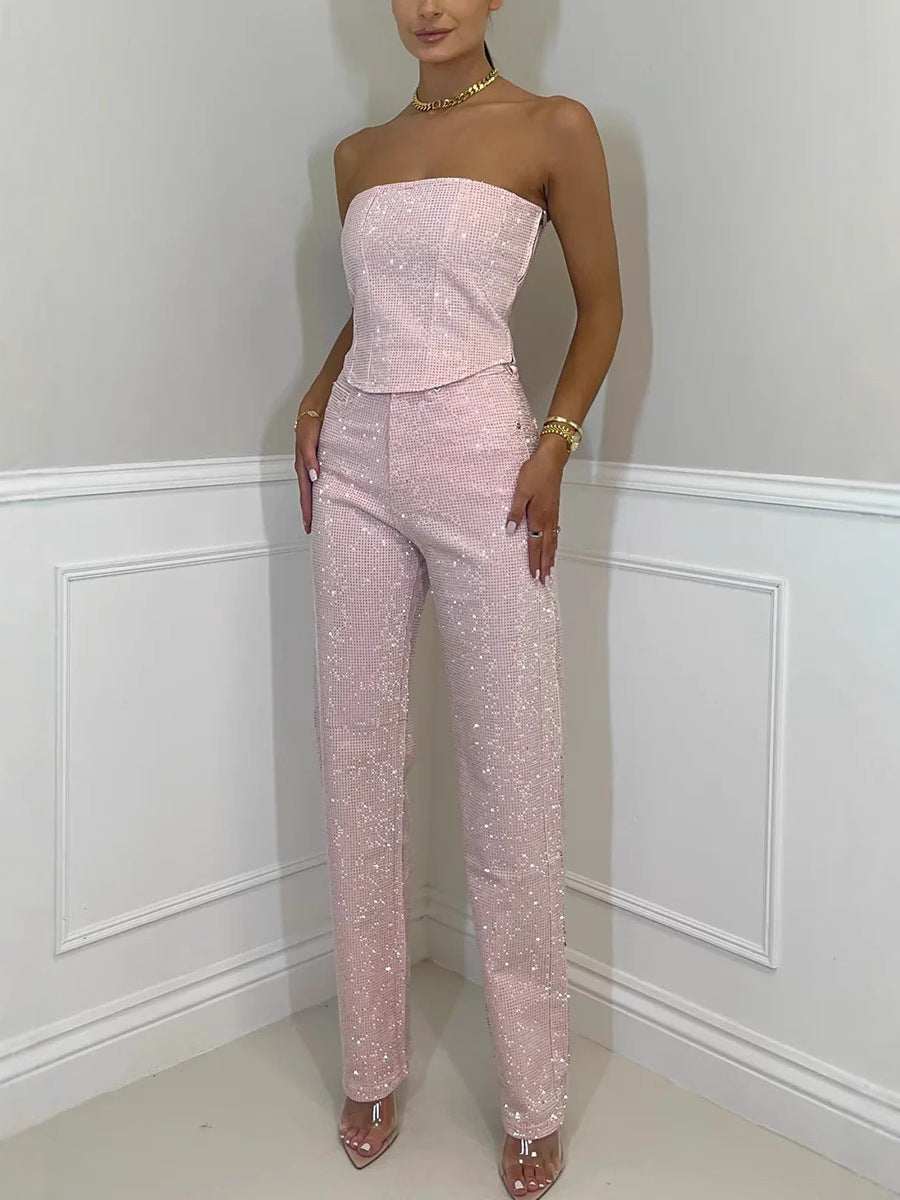 woman wearing pink shiny vest diamond trousers suit with strapless top and high-waisted pants