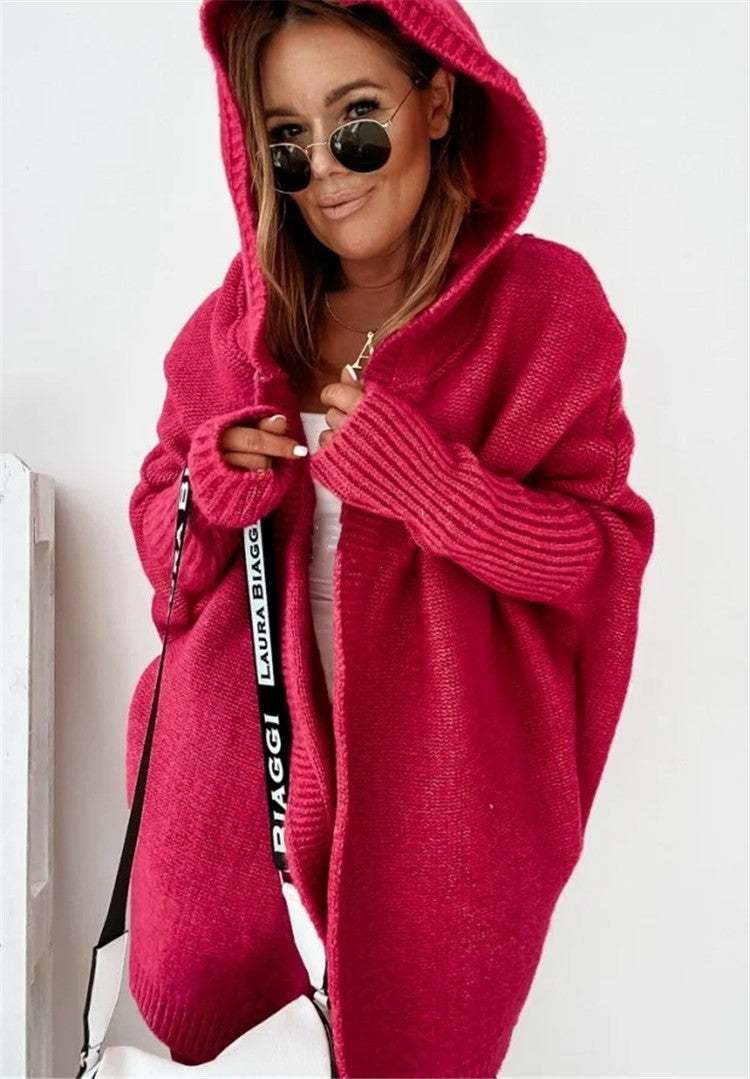 Woman wearing oversized loose bat sleeve hooded cardigan in red pink color