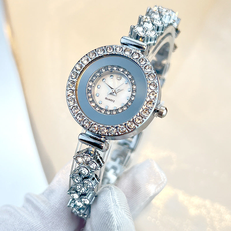 Diamond-encrusted glass rhinestone women's quartz watch in silver with crystal-studded band and round face