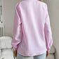 Back view of woman wearing pink striped long sleeve ruffle collar shirt with casual office style